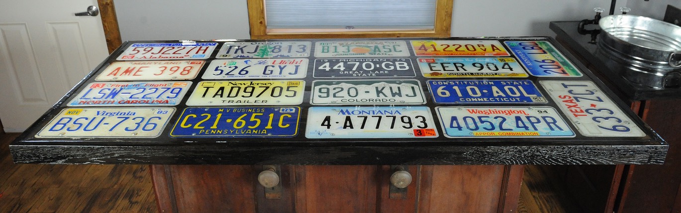 Home bar built out of circa 1930 recycled doors and old license plates for bar top
